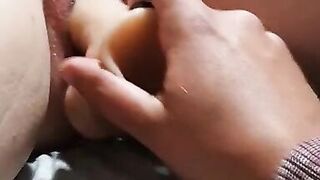 Hubby Filling Pussy with Dildo while he's Caged